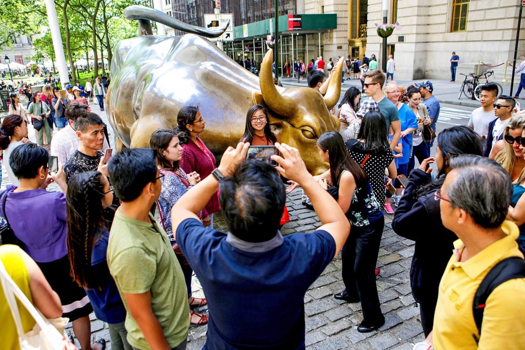 Tourists standing around the Charging Bull
