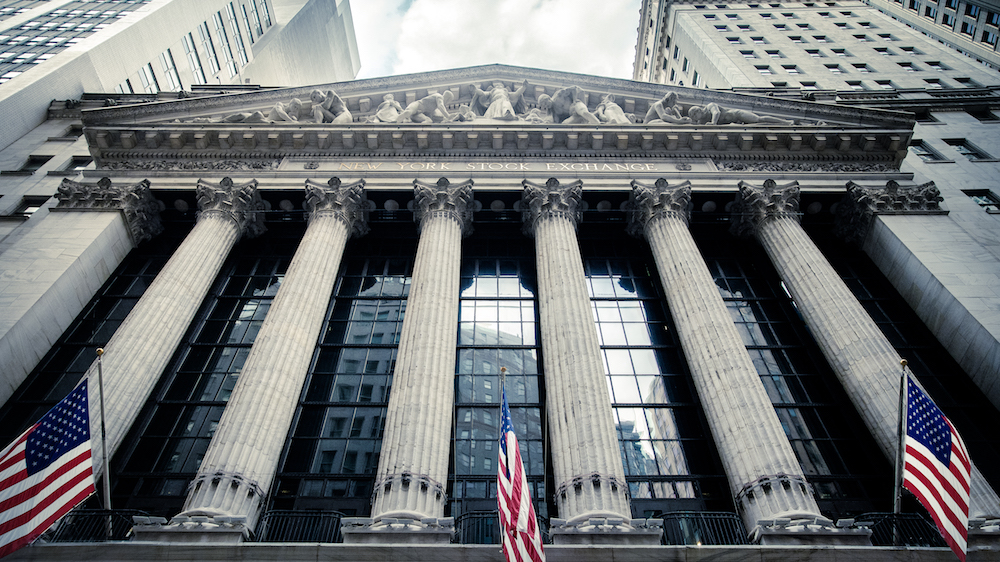 New York Stock Exchange with American flags hanging out front