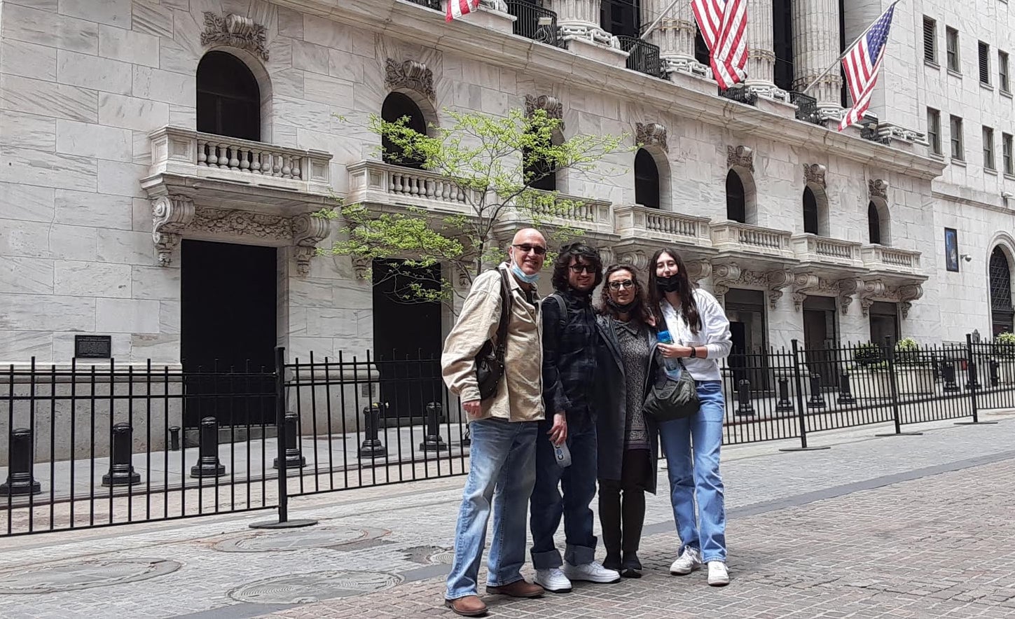 Tour group outside the NYSE with the Wall Street buttonwood tree in the background