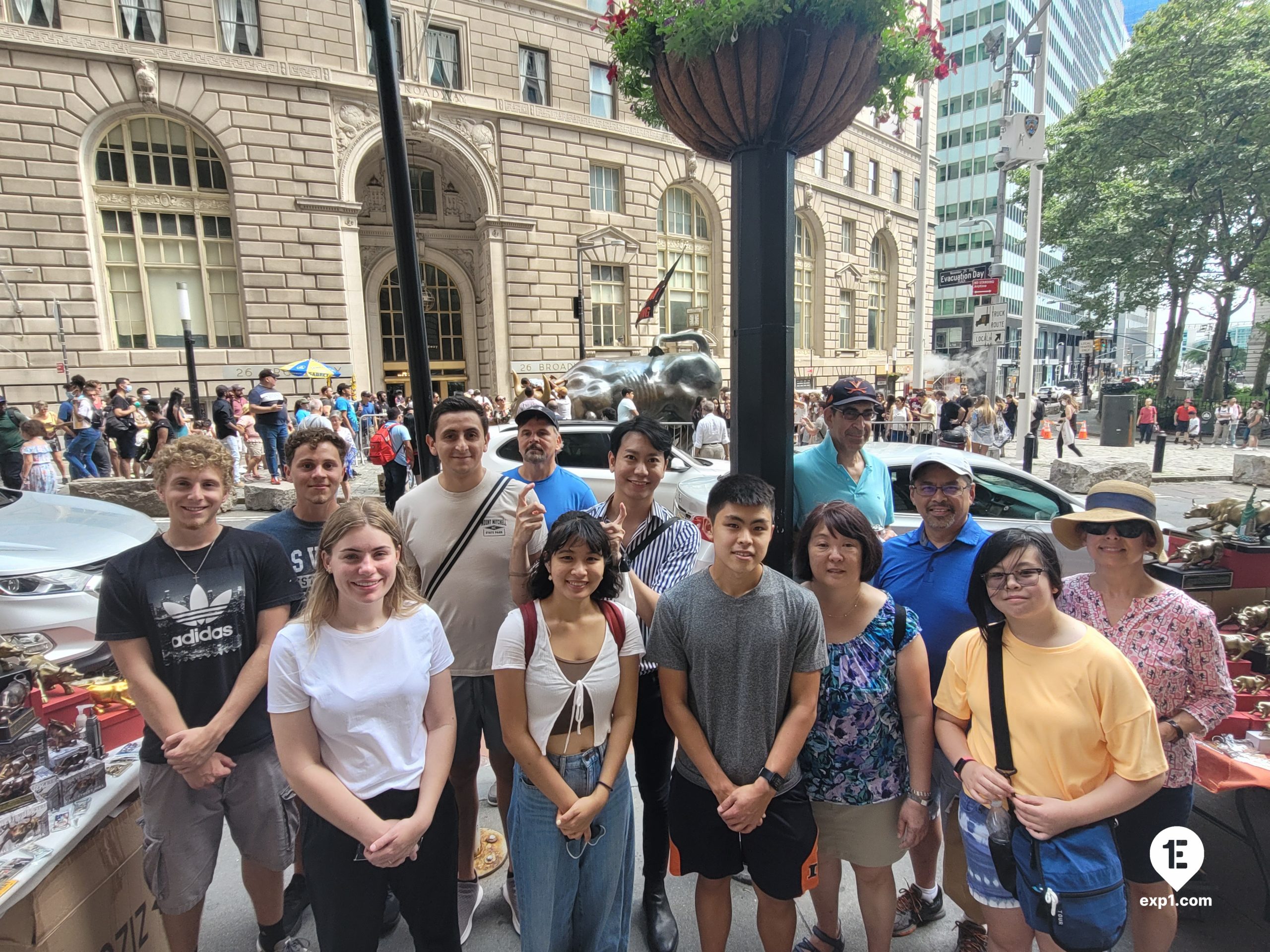 Wall Street Insider Tour guests pose for a pic near the Charging Bull.