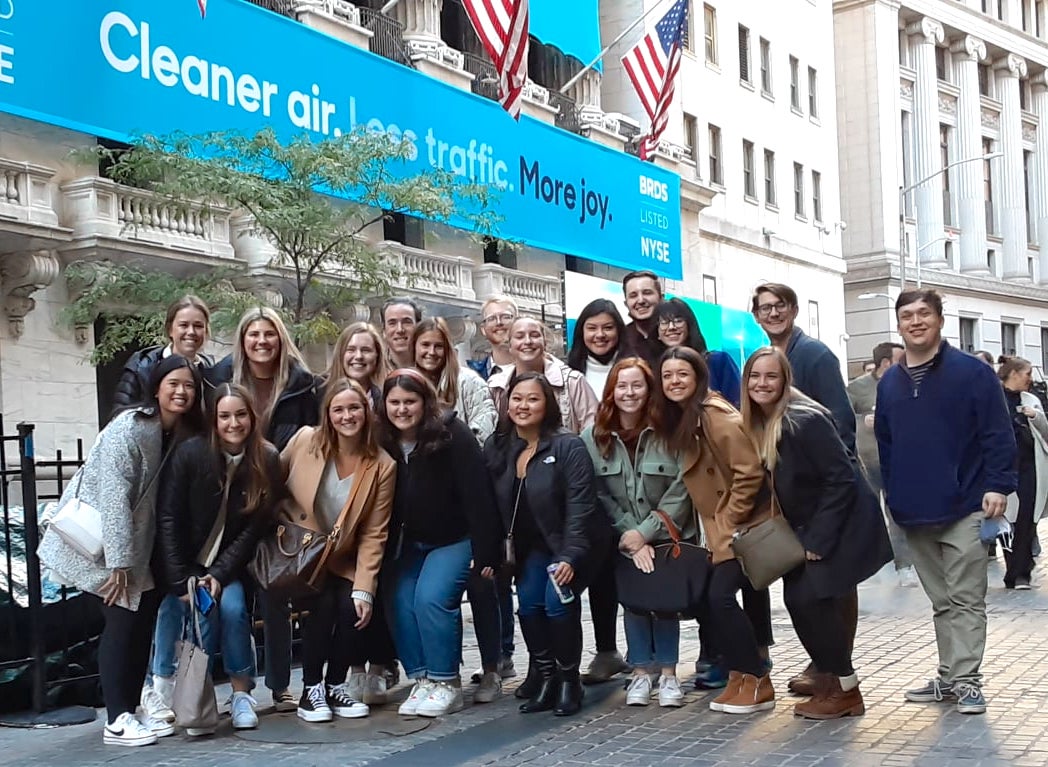 Tour group photo in front of the buttonwood tree on Wall Street