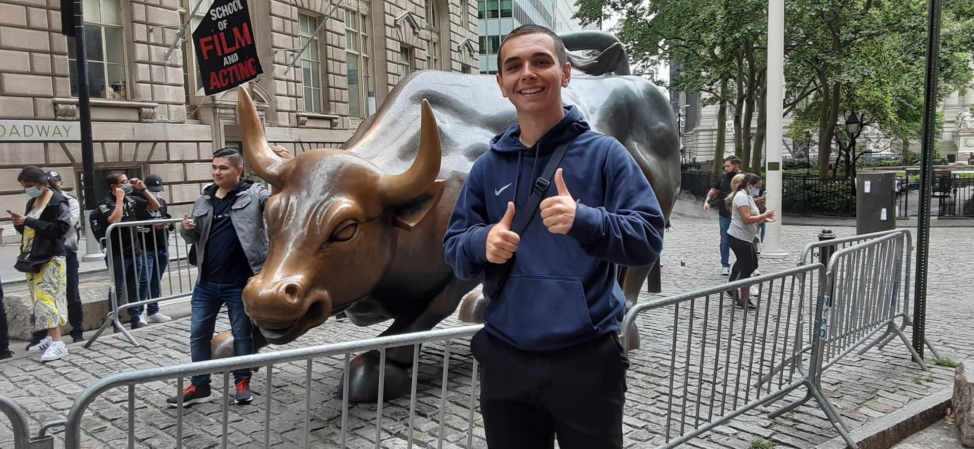 Tourists taking a photo with the Charging Bull in New York
