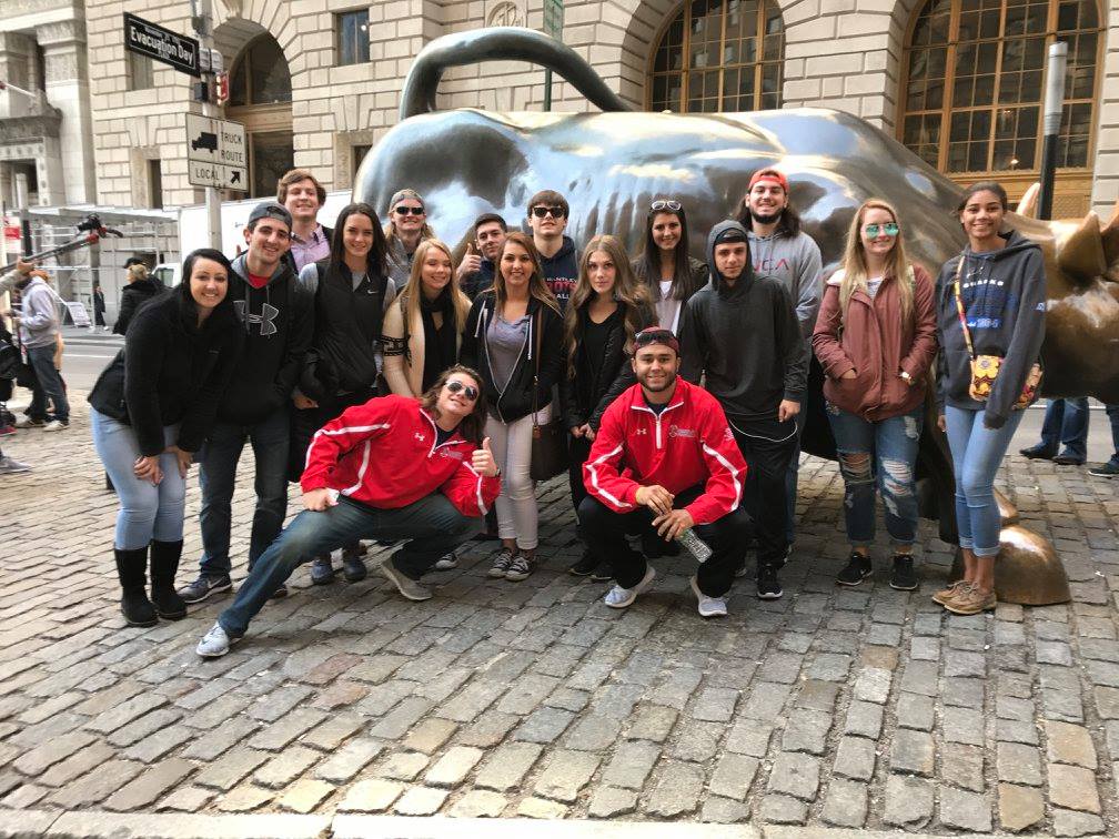 Tourists taking a photo with the Charging Bull in New York