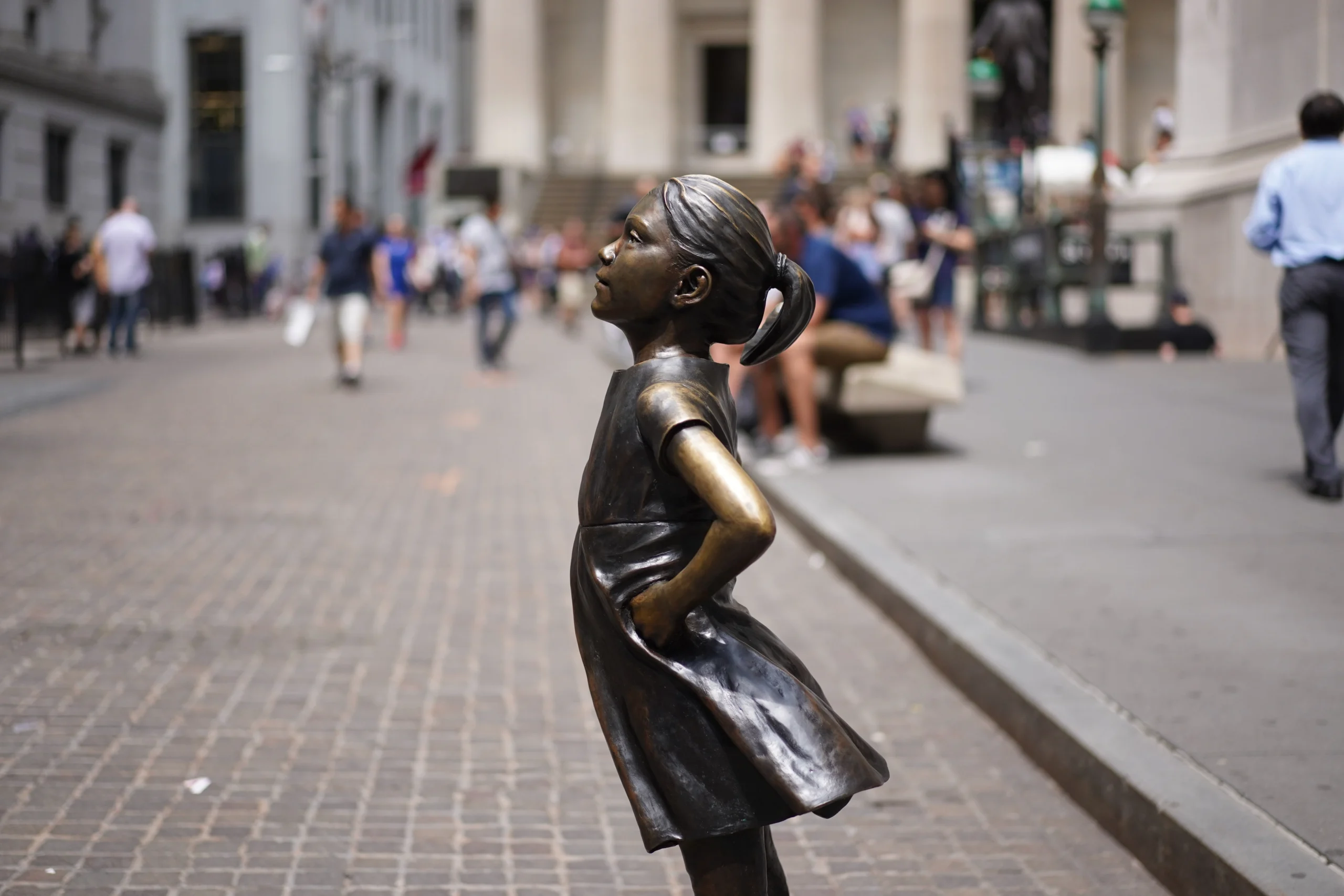 Side view of the Fearless Girl statue in Wall Street NYC