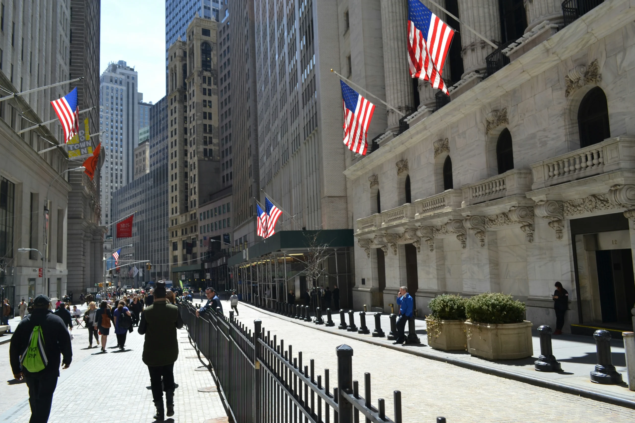 View of people walking down Wall Street during Private Wall Street with a Trader tour